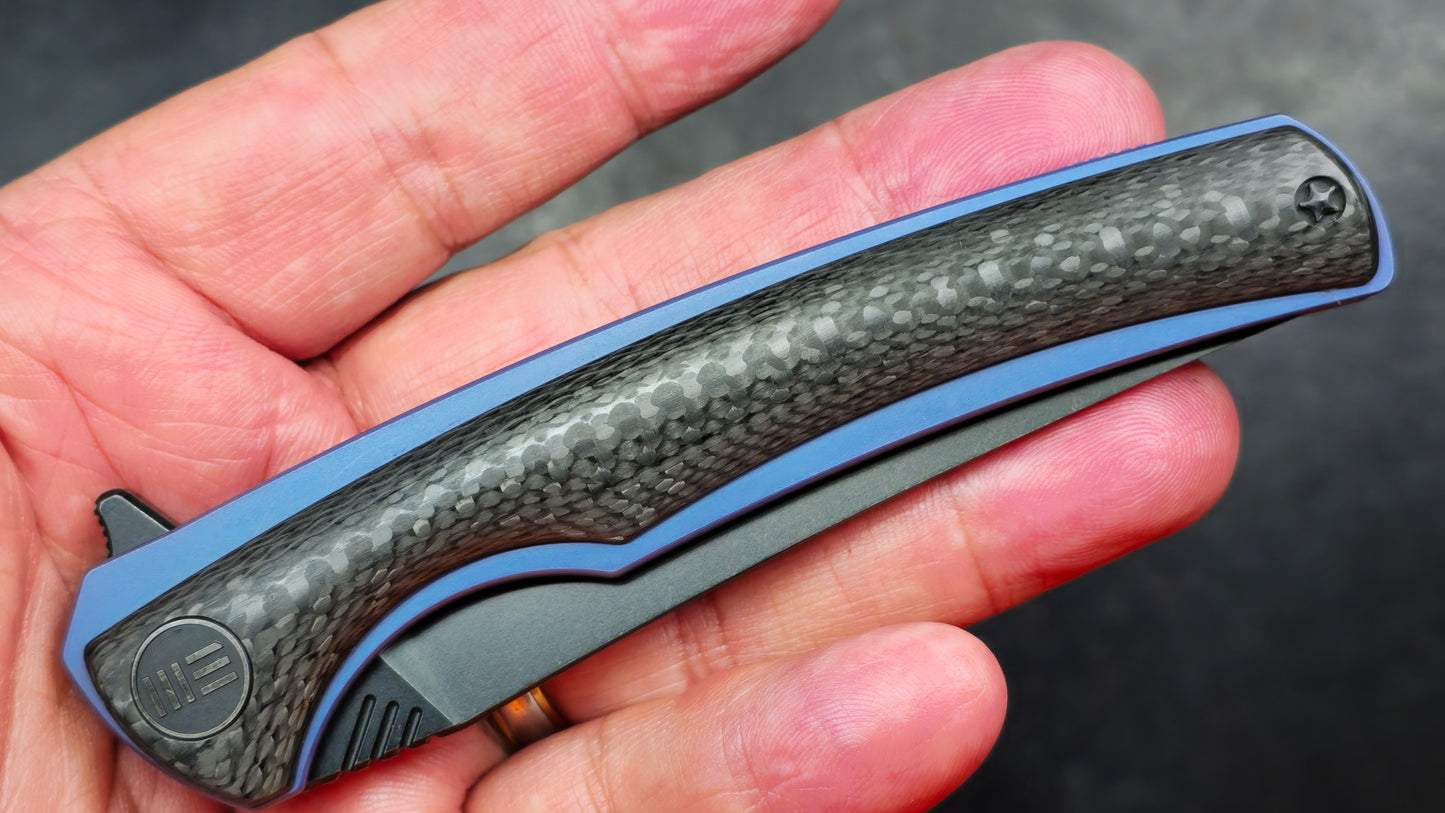 We Knife 704CF Black Carbon Fiber Over Blue Titanium Handle 3.6” Bohler M390 (NEW)