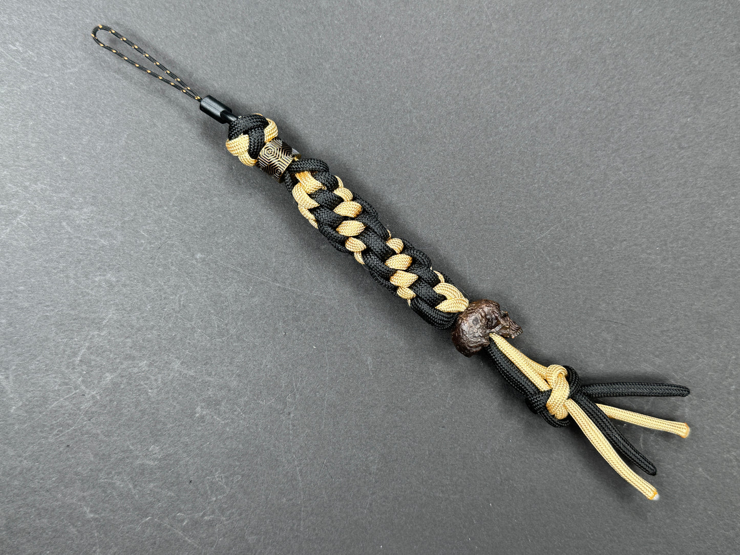 Custom Knife Lanyard โ Black & Gold Paracord with Handmade Skull Bead