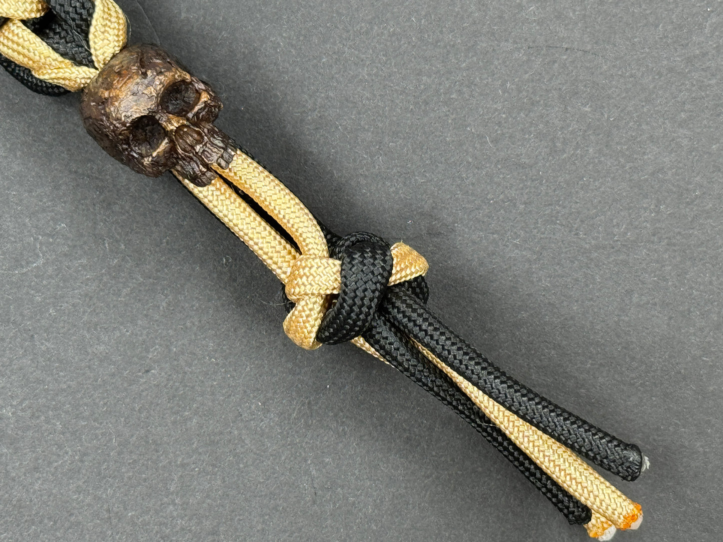 Custom Knife Lanyard โ Black & Gold Paracord with Handmade Skull Bead