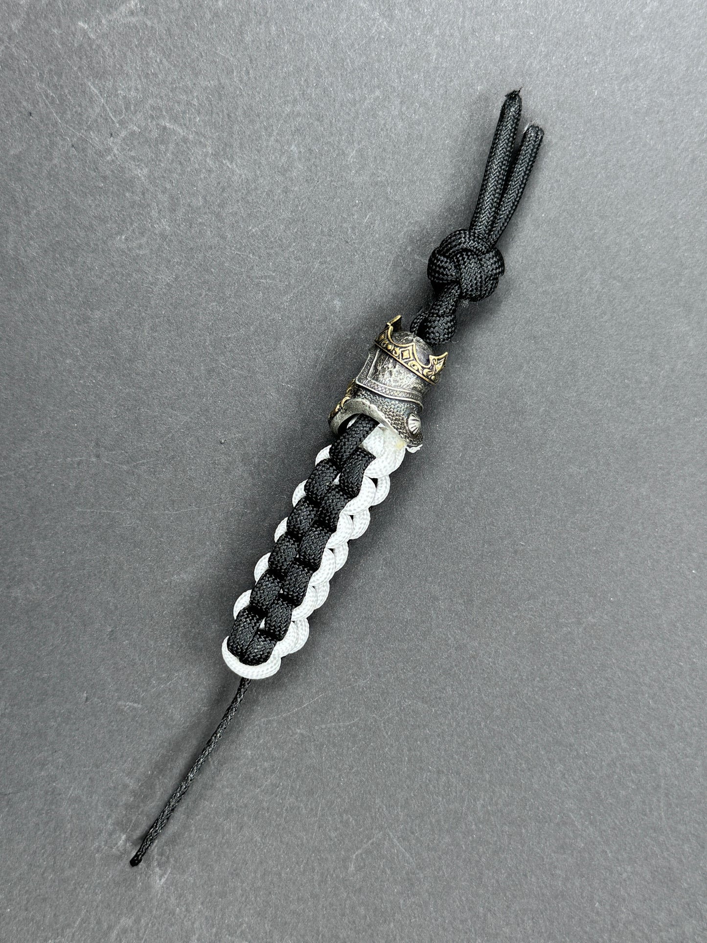 Custom Knife Lanyard โ Black & White Paracord with Intricate Skull King Bead