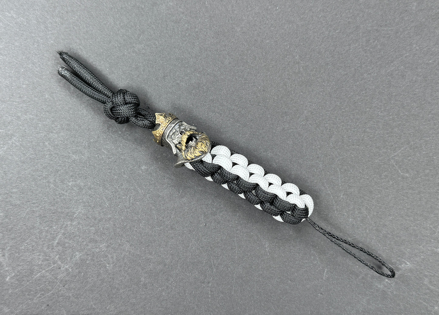 Custom Knife Lanyard โ Black & White Paracord with Intricate Skull King Bead