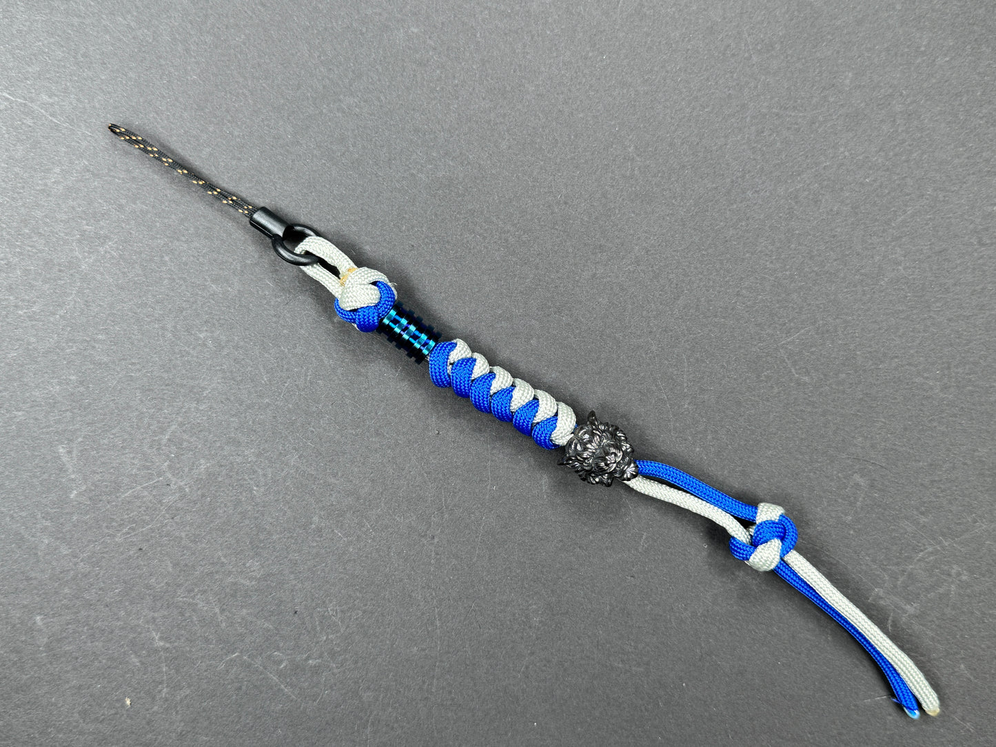 Custom Knife Lanyard โ Blue & White Paracord with Intricate Tiger Bead