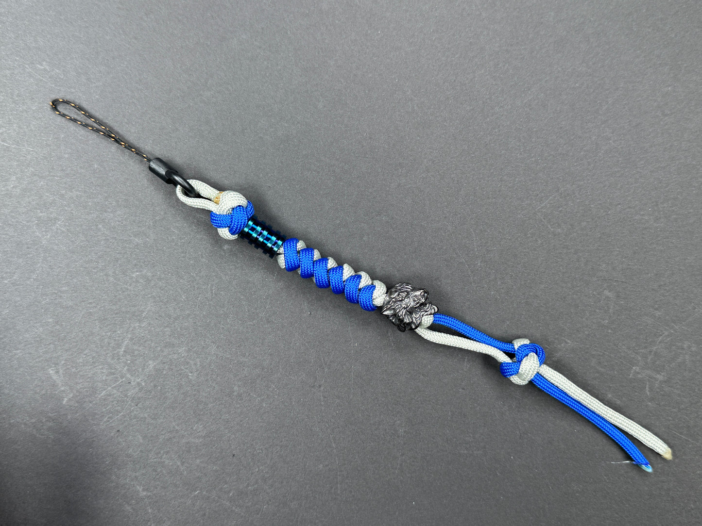 Custom Knife Lanyard โ Blue & White Paracord with Intricate Tiger Bead
