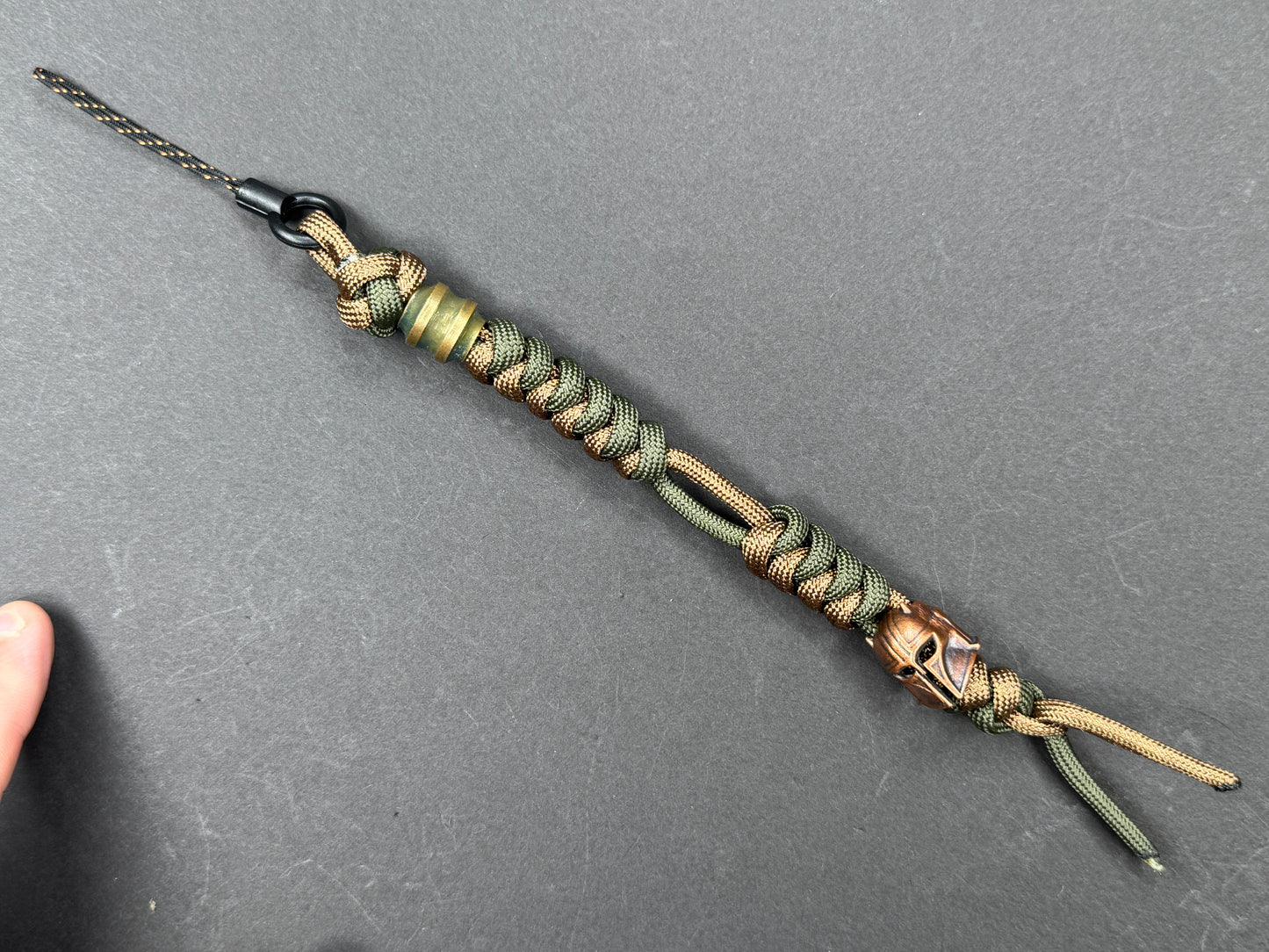 Custom Knife Lanyard โ Brown & Green Paracord with Intricate Warrior Helmet Bead