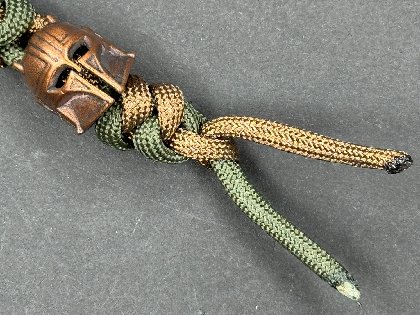 Custom Knife Lanyard โ Brown & Green Paracord with Intricate Warrior Helmet Bead