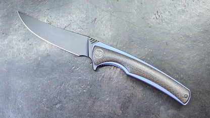 We Knife 704CF Black Carbon Fiber Over Blue Titanium Handle 3.6” Bohler M390 (NEW)